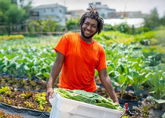 EarthShare-Homepage-Person-with-Vegetables-in-Garden-2