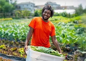 EarthShare-Homepage-Person-with-Vegetables-in-Garden