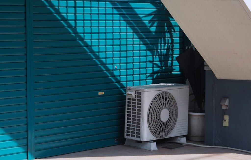 gray air conditioner against blue wall