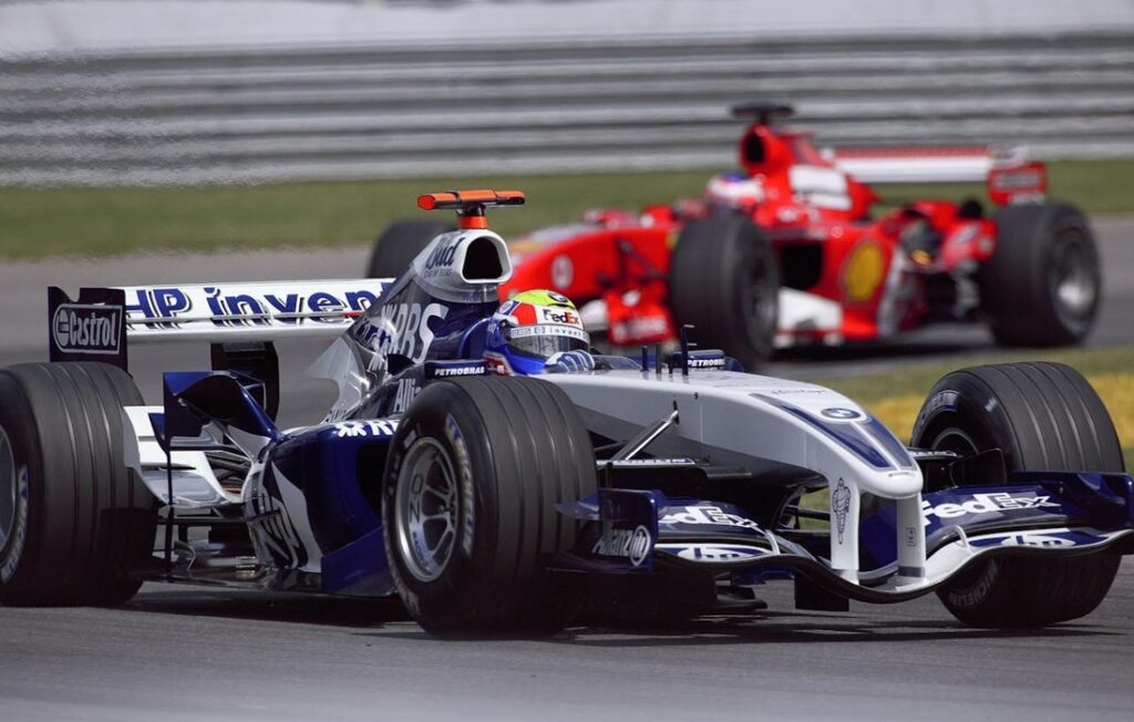 red and blue Indy 500 cars racing on track