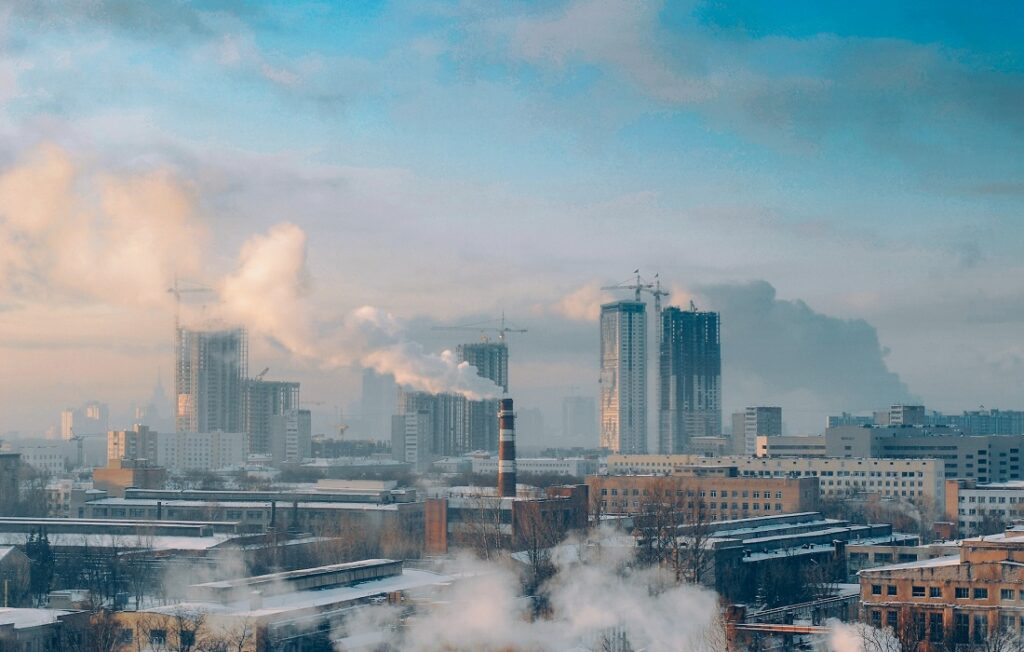 smokestacks release fumes over city